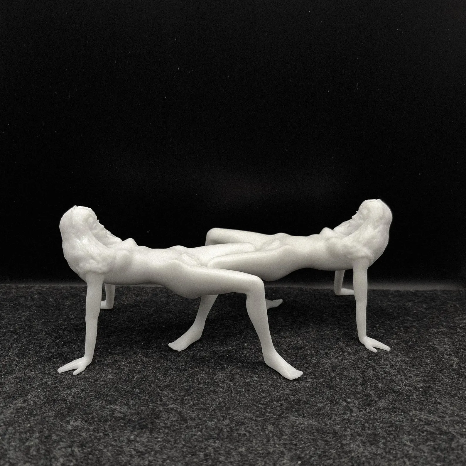 Two Korova Milk Bar Tables with white, unpainted hair against a black background