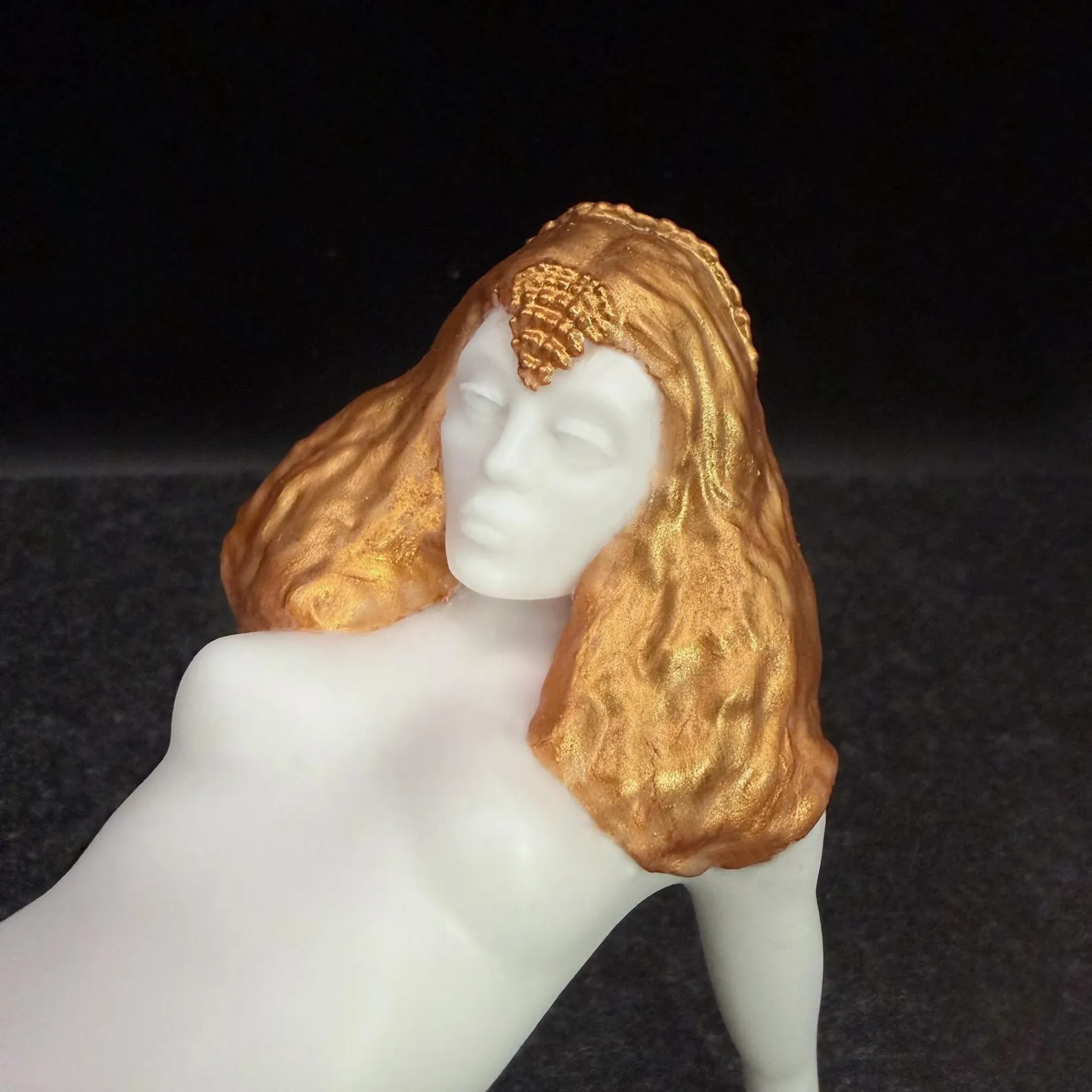 Close-up of a Korova Milk Bar Table showing orange hand-painted hair and a white face and body