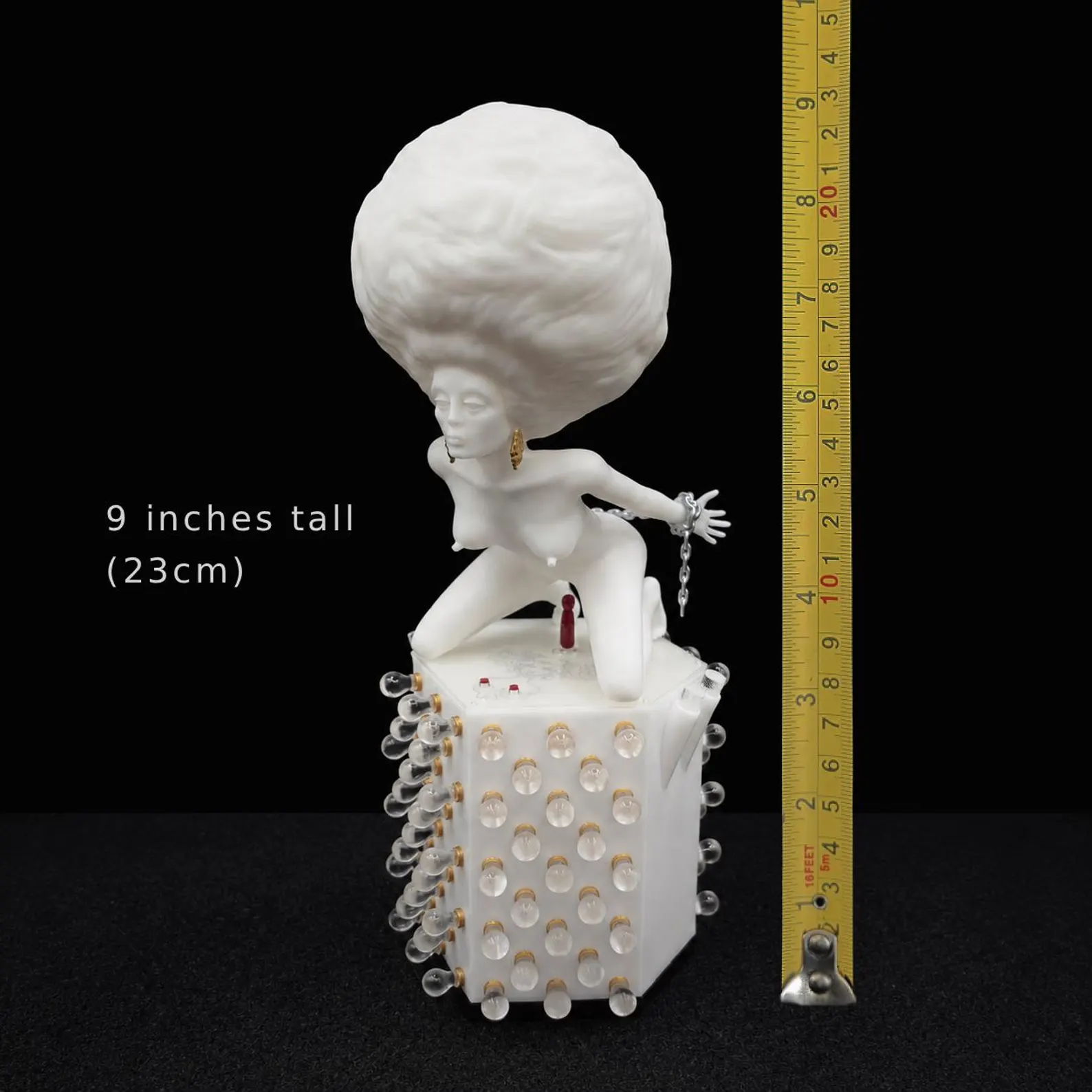 Korova Milk Bar Maid beside a measuring tape, labelled 9 inches tall (23 cm)